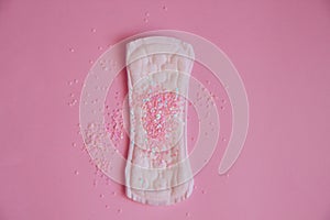 Woman menstrual pad with pink glitters