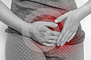 Woman with menstrual pain is holding her aching belly