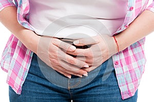 Woman with menstrual pain holding her aching belly