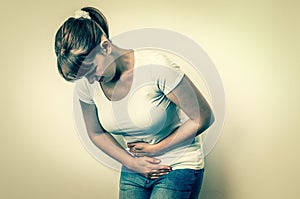 Woman with menstrual pain is holding her aching belly