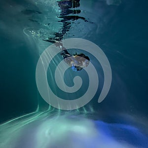 Woman with mermaid tail swims and dives underwater