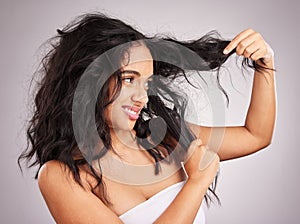 Woman, messy hair and disgust for entangled problem holding split ends against white studio background. Frustrated or