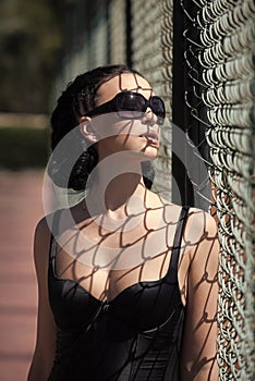 Woman with metallic net mesh shadow on skin