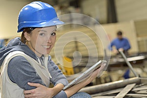 Woman in a metallurgic factory using tablet