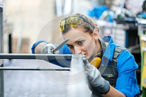 Woman metalworker checking the accuracy of her work photo