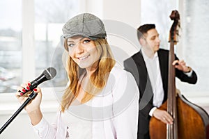 Woman with microphone and man contrabas