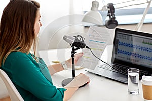 woman with microphone recording podcast at studio