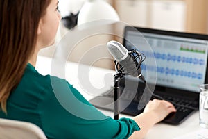 woman with microphone recording podcast at studio