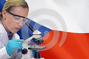 Woman with a microscope against Czech Republic flag background. Medical technology and pharmaceutical research in Czech Republic