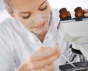 Woman, microscope and drop with test for laboratory research, scientific exam or discovery at clinic. Face of female