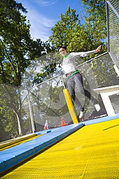 Woman in mid-air on trampoline