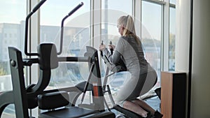 Woman of middle age working out in gym.