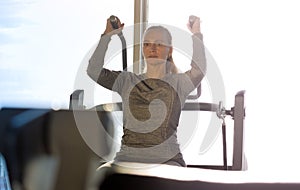 Woman of middle age working out in gym. photo