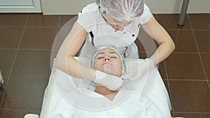 Woman middle-aged in spa salon with beautician. Botox injections.