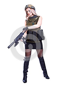 Woman in a military camouflage reloading the smg photo
