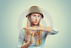 Woman in military capgesturing time out  with hand