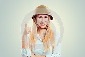 Woman in military helmet showing like thumb up