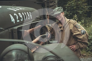 Woman in a military uniform in an army car