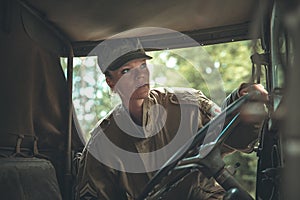 Woman in a military uniform in an army car