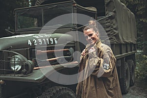 Woman in a military uniform in an army car