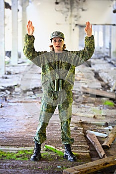 The woman in military uniform surrenders