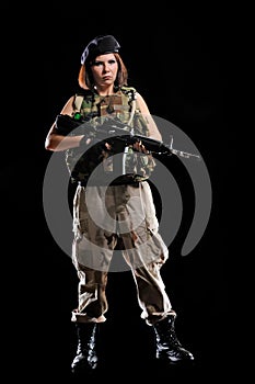 Woman in military uniform with weapon