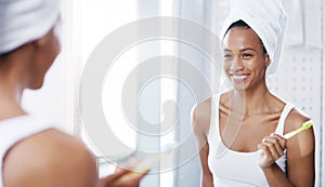 Woman, mirror and brushing teeth in bathroom with smile or towel after shower for hygiene, cleaning or oral care. Female