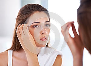 Woman, mirror and eyebrows with tweezers for beauty routine in bathroom for skincare, maintenance or cosmetic. Female
