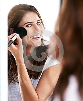 Woman, mirror and portrait with makeup brush in home or morning routine as cosmetics, skincare or confidence. Female