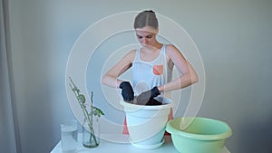 Woman mixes soil in flower pot, breakes pieces prepares to transplant of plants.