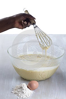 Woman mixing cake ingredients in a mixing bowl