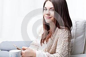 Woman mobile and mug with cappuccino photo