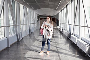 Woman with mobile phone standing in airport