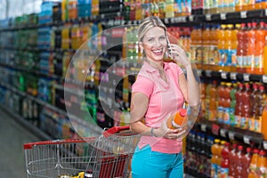 Woman With Mobile Phone in a Supermarket