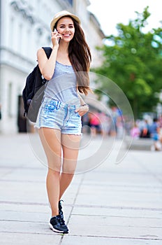 Woman with mobile phone walking