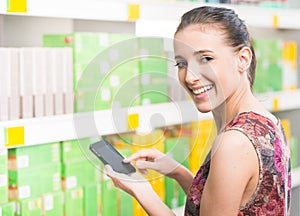 Woman with mobile at supermarket