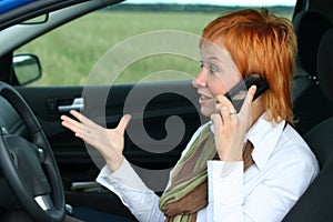 Woman with mobilein a car.