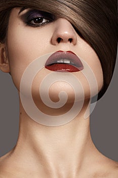 woman model with dark red lips & smooth hairstyle