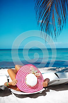 Woman model sunbathing on the beach chair