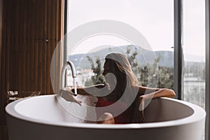 Woman in a modern bath tub