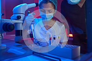 Woman in a modern cryo-laboratory works with biomaterial
