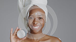 Woman, moisturizer and smile in portrait for skincare or beauty, health and wellness or dermatology. Happy black person