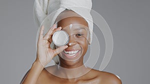 Woman, moisturizer and smile in portrait for skincare or beauty, health and wellness or dermatology. Happy black person