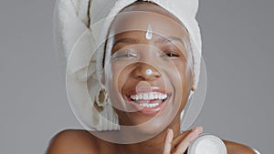 Woman, moisturizer and smile in portrait for skincare or beauty, health and wellness or dermatology. Happy black person