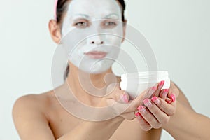 Woman moisturizing face