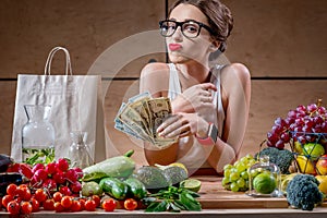 Woman with money cash and healthy food photo