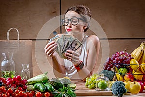 Woman with money cash and healthy food photo