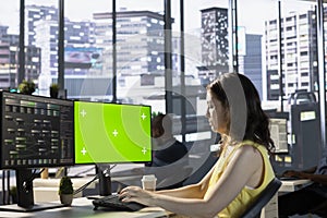 Woman monitoring and maintaining company systems using mockup PC photo