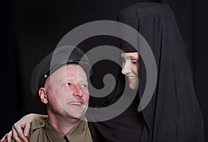 Woman in a monk robe and soldier.
