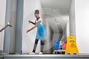 Woman Mopping Corridor